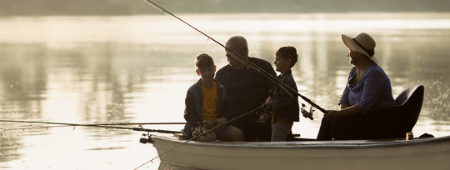 family fishing on boat