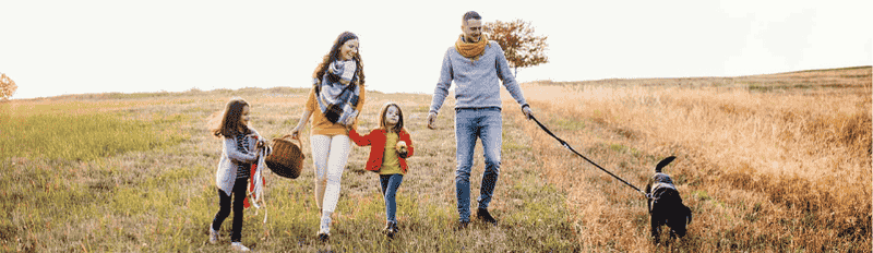 family outside walking dog