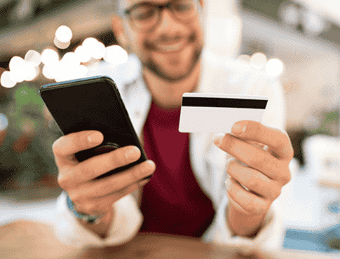 man with debit card and phone