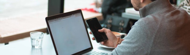 man on phone and laptop