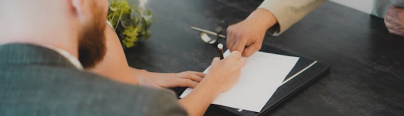 man and woman signing papers