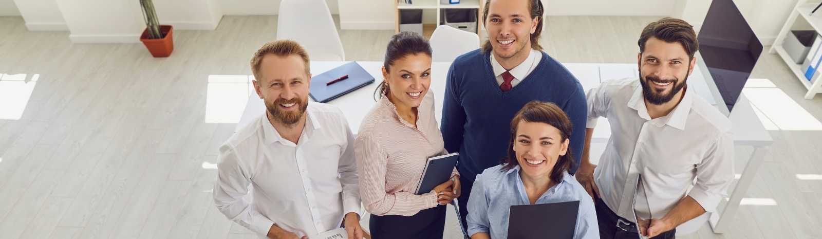 Group of employees looking up.