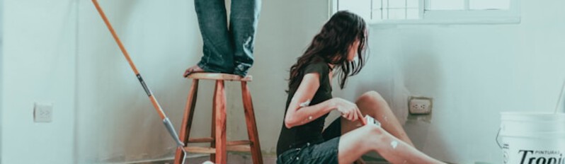 man and woman painting house