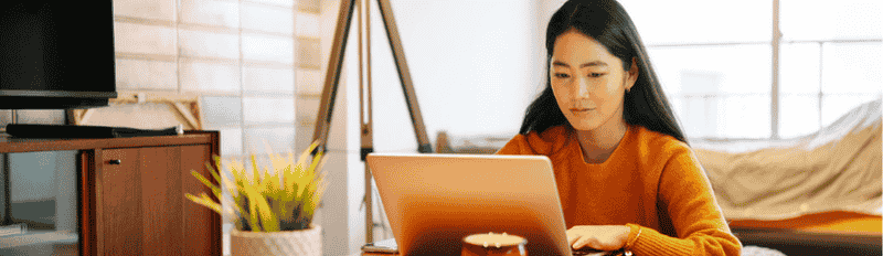 woman in orange on laptop