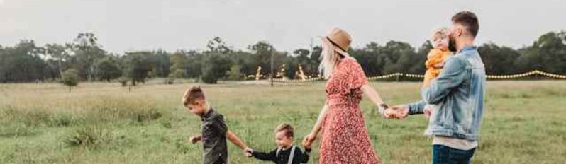 family of five playing in the grass